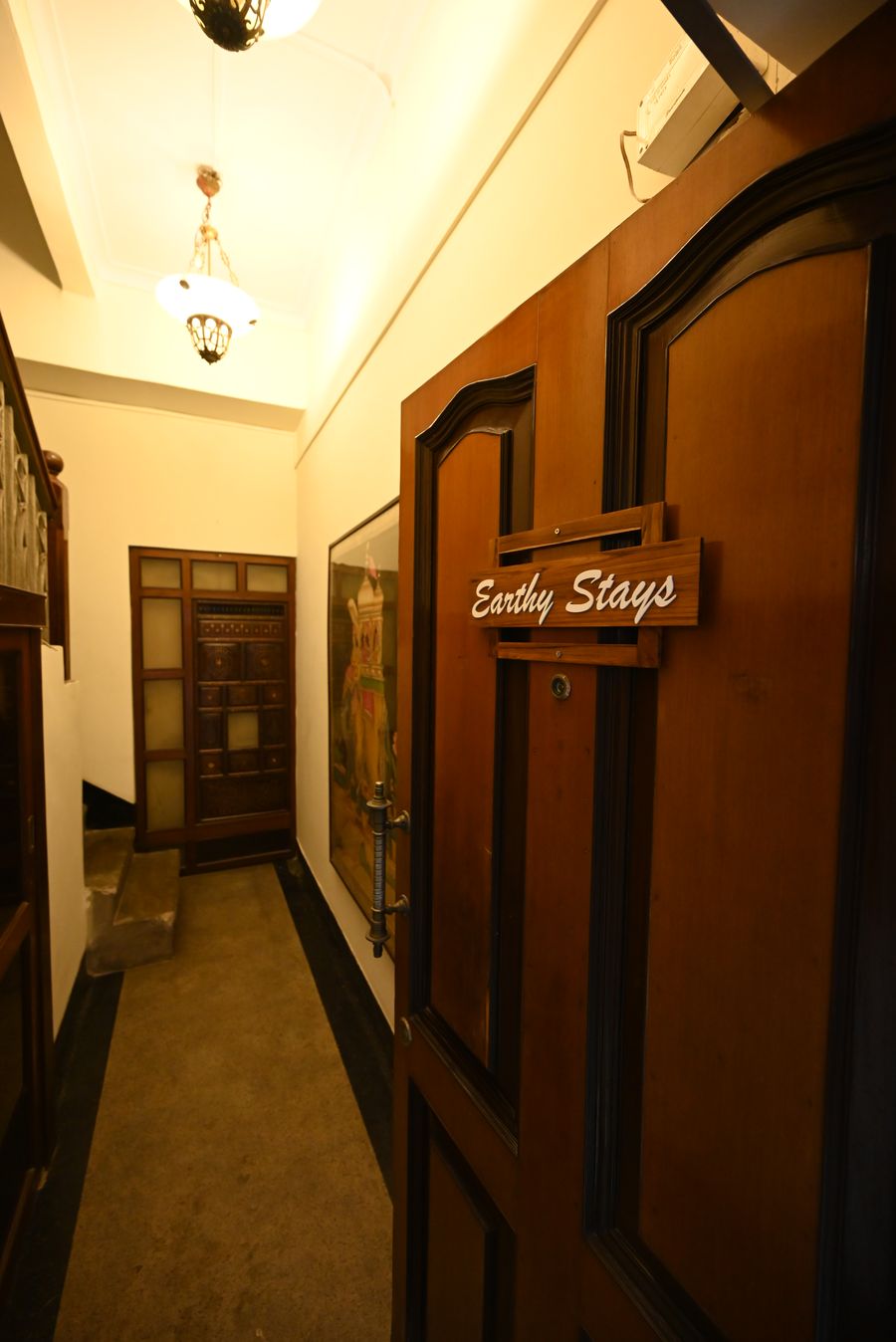 EarthyStays entrance door with wooden sign