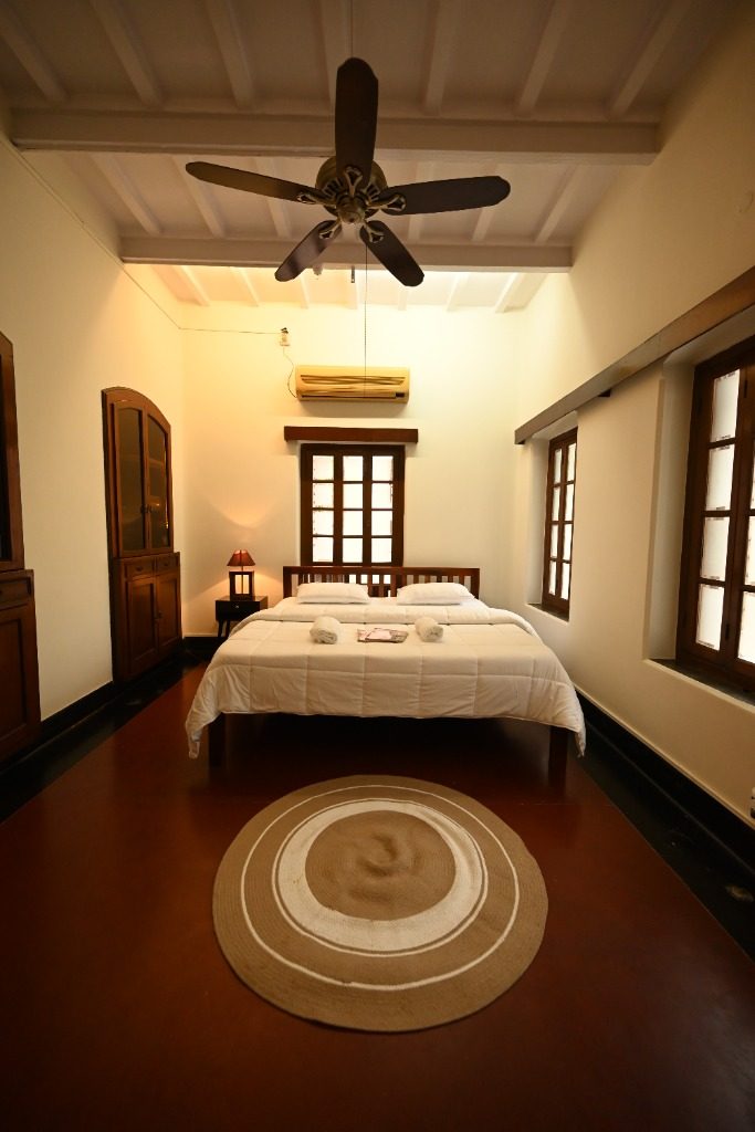 Spacious heritage bedroom with wooden ceiling fan