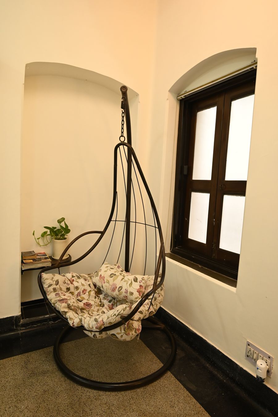 Cosy hanging swing chair in arched nook